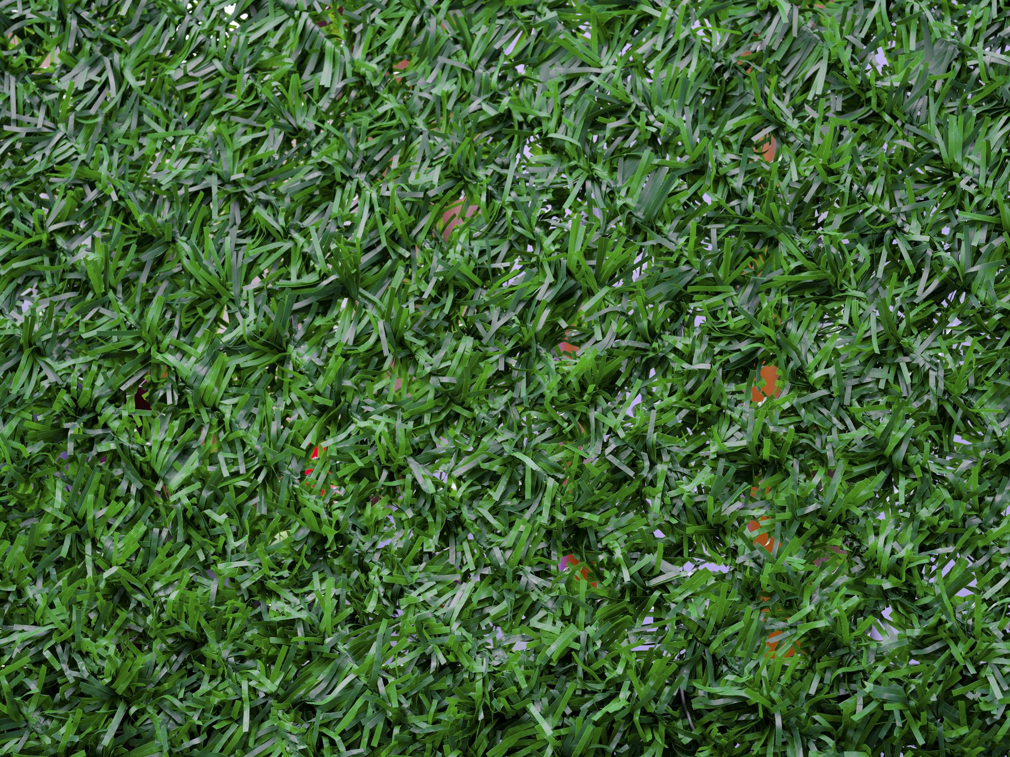Vibrant close-up image of synthetic green grass, perfect for backgrounds.